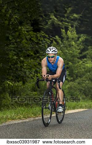 "Triathlete, 45 years, cycling, Kaiserstrassle road, Baden-Wurttemberg, Germany, Europe" View Large Photo Image Stock Photo - "Triathlete, 45 years, cycling, Kaiserstrassle road, Baden-Wurttemberg, Germany, Europe". Fotosearch