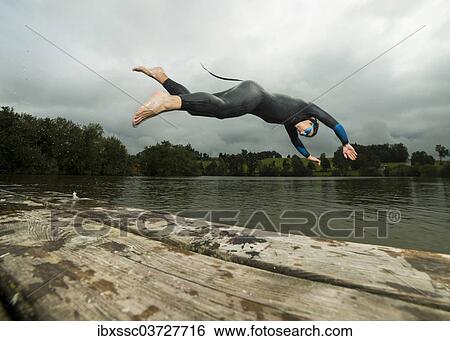 "Triathlete diving into Aichstruter Reservoir, Welzheim, Baden-Wurttemberg, Germany, Europe" View Large Photo Image Stock Photograph - "Triathlete diving into Aichstruter Reservoir, Welzheim, Baden-Wurttemberg, Germany, Europe". Fotosearch