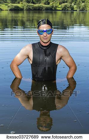 "Triathlete standing in Aichstruter Reservoir, Welzheim, Baden-Wurttemberg, Germany, Europe" View Large Photo Image Stock Photo - "Triathlete standing in Aichstruter Reservoir, Welzheim, Baden-Wurttemberg, Germany, Europe". Fotosearch