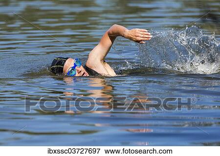 "Triathlete swimming, Welzheim, Baden-Wurttemberg, Germany, Europe" View Large Photo Image Stock Photo - "Triathlete swimming, Welzheim, Baden-Wurttemberg, Germany, Europe". Fotosearch