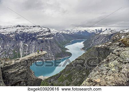 Stock Photograph - "Trolltunga, Troll's Tongue, Ringedalsvatn reservoir below, Folgefonn Glacier at the back, near Odda, Hordaland province, Vestland or Western Norway, Norway, Europe". Fotosearch