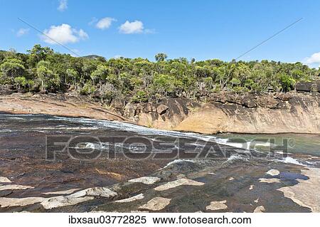 "Tropical dry forest landscape with river and rocks, water flowing over cascades, rocky riverbed, Andohahela National Park, near Fort-Dauphin or Tolagnaro, Madagascar, Africa" View Large Photo Image Stock Photography - "Tropical dry forest landscape with river and rocks, water flowing over cascades, rocky riverbed, Andohahela National Park, near Fort-Dauphin or Tolagnaro, Madagascar, Africa". Fotosearch