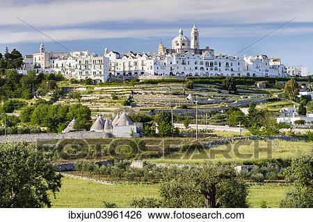 "Trulli, round cone houses, neoclassical church of San Giorgio Martire, 1790-1825, Locorotondo, Itria Valley, Apulia, Italy, Europe" View Large Photo Image Stock Photograph - "Trulli, round cone houses, neoclassical church of San Giorgio Martire, 1790-1825, Locorotondo, Itria Valley, Apulia, Italy, Europe". Fotosearch