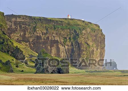 Stock Image - "Tuff rock with a lighthouse, Dyrholaey, Vik i Myrdal, Southern Region, Iceland, Europe". Fotosearch