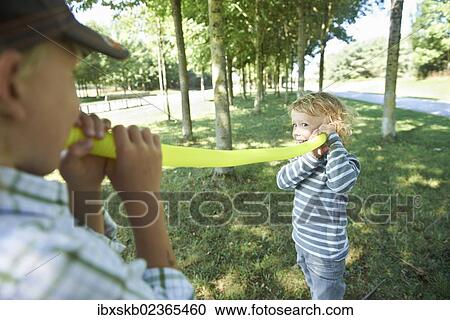 Two boys playing with a voice tube View Large Photo Image Stock Image - Two boys playing with a voice tube. Fotosearch