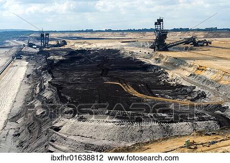 "Two bucket excavators and a coal seam in the open pit in Garzweiler, North Rhine-Westphalia, Germany, Europe" View Large Photo Image Stock Image - "Two bucket excavators and a coal seam in the open pit in Garzweiler, North Rhine-Westphalia, Germany, Europe". Fotosearch
