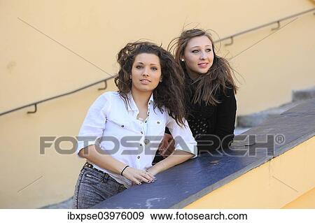 Stock Photo - "Two girlfriends, teenagers, posing on a staircase, Menton, Alpes-Maritimes, Provence-Alpes-Cote d'Azur, France, Europe". Fotosearch