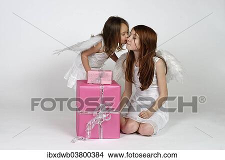 "Two girls as angels, with Christmas gifts" View Large Photo Image Picture - "Two girls as angels, with Christmas gifts". Fotosearch