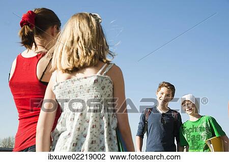 Two girls meeting two boys View Large Photo Image Stock Image - Two girls meeting two boys. Fotosearch