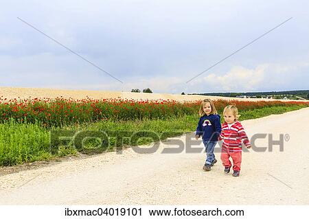 "Two girls on dirt road at Sontheim, Baden-Wurttemberg, Germany, Europe" View Large Photo Image Stock Image - "Two girls on dirt road at Sontheim, Baden-Wurttemberg, Germany, Europe". Fotosearch