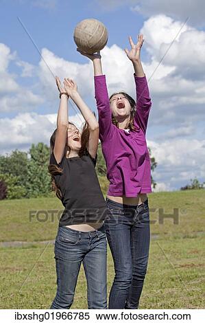 Two girls playing wth ball View Large Photo Image Stock Photography - Two girls playing wth ball. Fotosearch