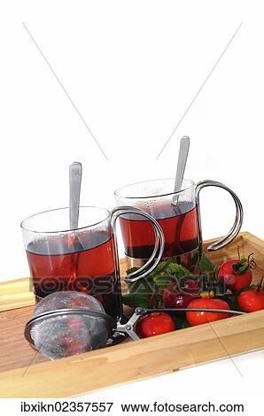 Two glasses of rose hip tea and rose hips on a wooden try View Large Photo Image Stock Photo - Two glasses of rose hip tea and rose hips on a wooden try. Fotosearch
