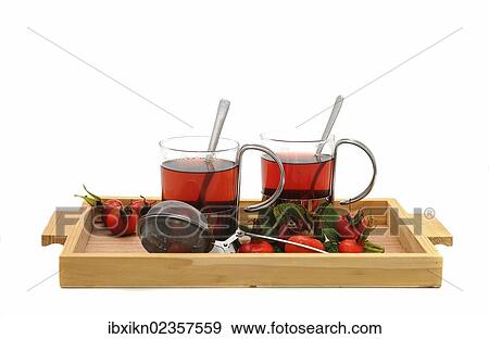 Two glasses of rose hip tea and rose hips on a wooden tray View Large Photo Image Stock Photo - Two glasses of rose hip tea and rose hips on a wooden tray. Fotosearch