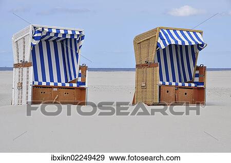 "Two roofed wicker beach chairs, beach on the North Sea, St. Peter-Ording, Schleswig-Holstein, Germany, Europe" View Large Photo Image Stock Photo - "Two roofed wicker beach chairs, beach on the North Sea, St. Peter-Ording, Schleswig-Holstein, Germany, Europe". Fotosearch