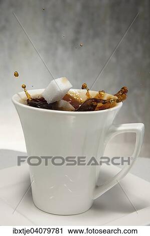 Two sugar cubes falling into a cup of coffee View Large Photo Image Stock Image - Two sugar cubes falling into a cup of coffee. Fotosearch