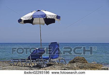 "Two sun loungers and a parasol at the beach, Stalida, Stalis, Crete, Greece, Europe" View Large Photo Image Stock Photograph - "Two sun loungers and a parasol at the beach, Stalida, Stalis, Crete, Greece, Europe". Fotosearch