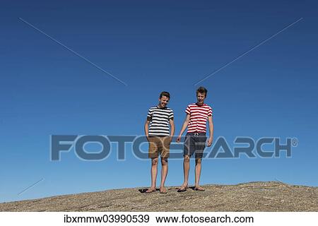 "Two teenagers standing on Mt Vogelfederberg, Namib-Naukluft National Park, Namibia, Africa" View Large Photo Image Stock Photo - "Two teenagers standing on Mt Vogelfederberg, Namib-Naukluft National Park, Namibia, Africa". Fotosearch