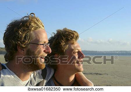 "Two young men laughing and embracing, Brittany, France, Europe" View Large Photo Image Stock Image - "Two young men laughing and embracing, Brittany, France, Europe". Fotosearch