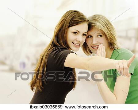 "Two young women, friends, whispering and gossiping" View Large Photo Image Stock Photo - "Two young women, friends, whispering and gossiping". Fotosearch