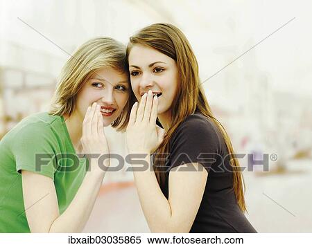 "Two young women, friends, whispering and gossiping" View Large Photo Image Stock Photography - "Two young women, friends, whispering and gossiping". Fotosearch