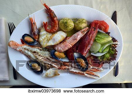 "Typical fish dish with shrimps, mussels, whiting, octopus, boiled potatoes, Lanzarote, Canary Islands, Spain, Europe" View Large Photo Image Stock Photo - "Typical fish dish with shrimps, mussels, whiting, octopus, boiled potatoes, Lanzarote, Canary Islands, Spain, Europe". Fotosearch