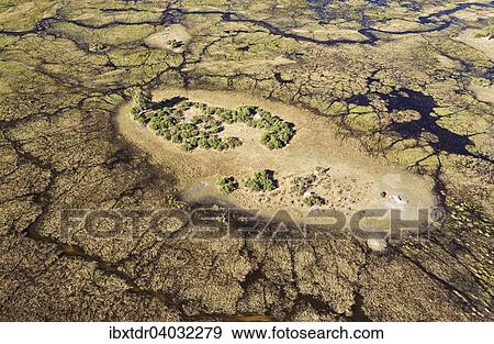 Stock Photo - "Typical landscape of freshwater marshes with streams, channels and islands, aerial view, Okavango Delta, Botswana, Africa". Fotosearch