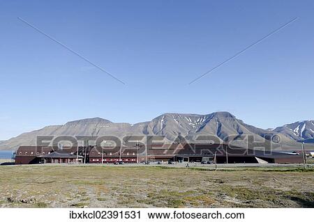 Stock Image - "UNIS, University Centre in Svalbard, Svalbard Museum and Tourist Bureau, in front of Hjorthfjellet Mountain in Adventfjorden, Longyearbyen, Spitsbergen, Svalbard, Norway, Europe". Fotosearch