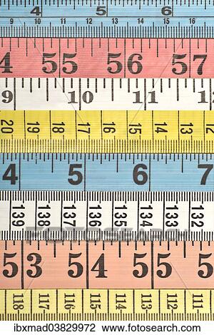 Stock Image - Various colourful measuring tapes. Fotosearch