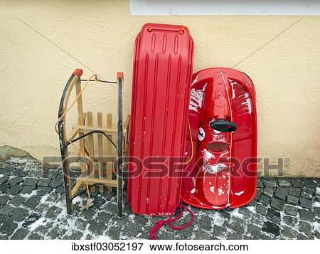 Various sledges leaning against a house wall View Large Photo Image Stock Photo - Various sledges leaning against a house wall. Fotosearch