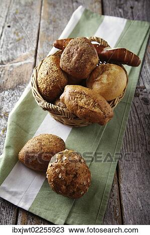 Various types of bread in a basket lying on a rustic table View Large Photo Image Stock Image - Various types of bread in a basket lying on a rustic table. Fotosearch