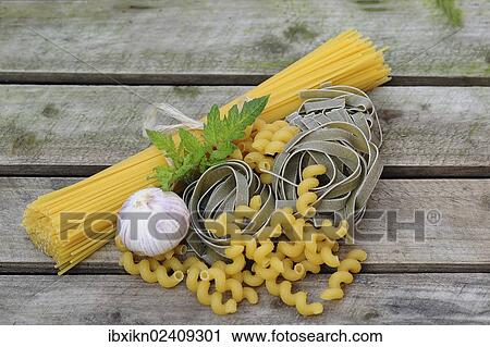 Various types of pasta on a wooden board View Large Photo Image Stock Image - Various types of pasta on a wooden board. Fotosearch