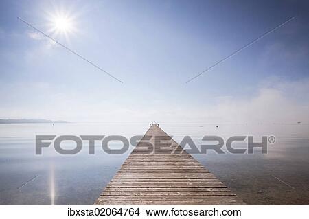 "Very long jetty on Chiemsee Lake with high fog and sun near Seebruck, Bavaria, Germany, Europe, PublicGround, Europe" View Large Photo Image Picture - "Very long jetty on Chiemsee Lake with high fog and sun near Seebruck, Bavaria, Germany, Europe, PublicGround, Europe". Fotosearch