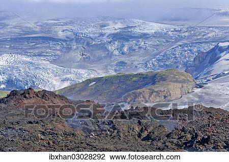 Stock Image - "View across new lava fields created by a volcanic eruption in 2010 to the Myrdalsjokull glacier, at the long-distance hiking trail from Skogar via Fimmvorouhals to the Thorsmork mountain ridge, Porsmork, Iceland, Europe". Fotosearch