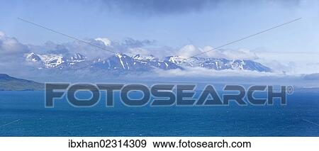 Stock Photo - "View across the Eyjafoerdur to the snow-capped mountains near Dalvik, Akureyri, Iceland, Europe". Fotosearch