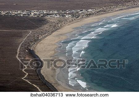 "View from Mirador del Bosquecillo, Risco de Famara, Famara beach at Playa de Famara, resort Famara, Lanzarote, Canary Islands, Spain, Europe" View Large Photo Image Stock Image - "View from Mirador del Bosquecillo, Risco de Famara, Famara beach at Playa de Famara, resort Famara, Lanzarote, Canary Islands, Spain, Europe". Fotosearch