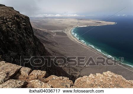 "View from Mirador del Bosquecillo, Risco de Famara, on Famara beach or Playa de Famara with La Calaeta and Famara resort, Lanzarote, Canary Islands, Spain, Europe" View Large Photo Image Stock Photo - "View from Mirador del Bosquecillo, Risco de Famara, on Famara beach or Playa de Famara with La Calaeta and Famara resort, Lanzarote, Canary Islands, Spain, Europe". Fotosearch