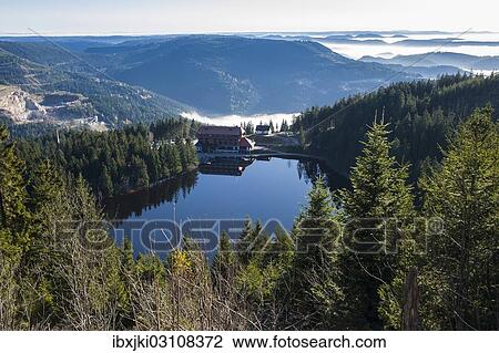 Stock Image - "View from Mt Hornisgrinde to Mummelsee Lake with Berghotel Mummelsee, Seebach, Nordschwarzwald, Schwarzwald, Baden-Wurttemberg, Germany, Europe". Fotosearch