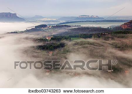 Stock Image - "View from the Bastei rock formation, morning mist, Saxon Switzerland National Park, Saxon Switzerland region, Saxony, Germany, Europe". Fotosearch