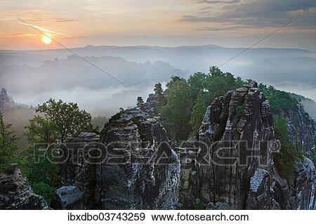 "View from the Bastei rock formation, sunrise, fog, Saxon Switzerland National Park, Saxon Switzerland region, Saxony, Germany, Europe" View Large Photo Image Stock Photo - "View from the Bastei rock formation, sunrise, fog, Saxon Switzerland National Park, Saxon Switzerland region, Saxony, Germany, Europe". Fotosearch