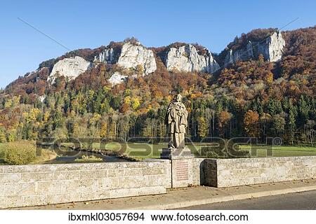 Picture - "View from the Hausener bridge with the statue of St. Nepomuk towards the Hausener Zinnen rocks, Hausen im Tal, Schwabische Alb, Baden-Wurttemberg, Germany, Europe". Fotosearch