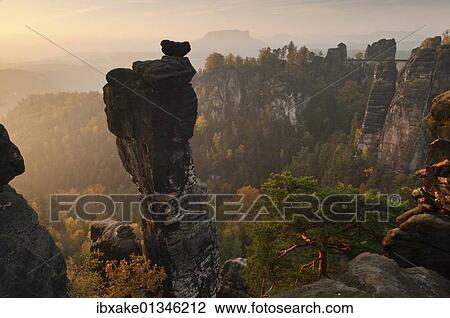 "View from the Hoellenhundaussicht view over the Wehlgrund valley to the Bastei rock formation and Basteibruecke bridge, dawn, sunrise, autumn, Saxon Switzerland, Saxony, Germany, Europe" View Large Photo Image Stock Image - "View from the Hoellenhundaussicht view over the Wehlgrund valley to the Bastei rock formation and Basteibruecke bridge, dawn, sunrise, autumn, Saxon Switzerland, Saxony, Germany, Europe". Fotosearch