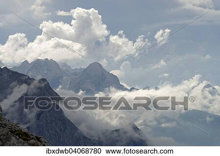 "View from the Karwendelbahn, Karwendel Railway, on the Wetterstein range with Alpine peaks and atmospheric clouds, near Mittenwald, Karwendel, range, Werdenfelser Land, Upper Bavaria, Bavaria, Germany, Europe" View Large Photo Image Stock Image - "View from the Karwendelbahn, Karwendel Railway, on the Wetterstein range with Alpine peaks and atmospheric clouds, near Mittenwald, Karwendel, range, Werdenfelser Land, Upper Bavaria, Bavaria, Germany, Europe". Fotosearch