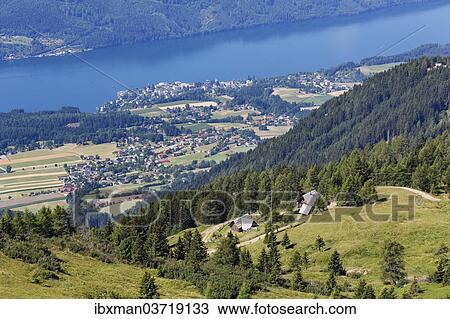 Stock Image - "View from the Millstatt Alps over Millstatt am See and Lake Millstatt, Millstatter Alpe massif, Central Eastern Alps, Millstatt am See, Spittal an der Drau, Carinthia, Austria, Europe". Fotosearch