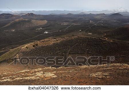 "View from the Montana de Guardilama range north on the wine growing region of La Geria and volcanic landscape with volcanic mountains, Lanzarote, Canary Islands, Spain, Europe" View Large Photo Image Stock Photograph - "View from the Montana de Guardilama range north on the wine growing region of La Geria and volcanic landscape with volcanic mountains, Lanzarote, Canary Islands, Spain, Europe". Fotosearch