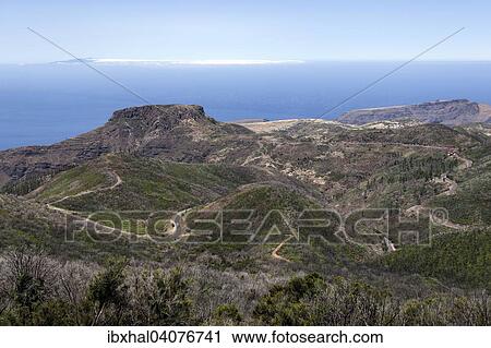 "View from the summit of Garajonay on charred shrubs, traces of the forest fire of 2012, behind the Fortalezza, on the horizon the island of El Hierro, La Gomera, Canary Islands, Spain, Europe" View Large Photo Image Stock Image - "View from the summit of Garajonay on charred shrubs, traces of the forest fire of 2012, behind the Fortalezza, on the horizon the island of El Hierro, La Gomera, Canary Islands, Spain, Europe". Fotosearch