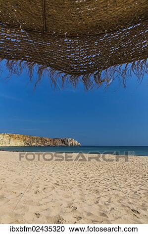 "View from underneath a parasol out onto the beach, Praia da Mareta, Sagres, Algarve, Portugal, Europe" View Large Photo Image Stock Image - "View from underneath a parasol out onto the beach, Praia da Mareta, Sagres, Algarve, Portugal, Europe". Fotosearch