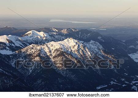 Stock Photo - "View from Zugspitze Mountain over Kramerspitz Mountain in the Ammer Mountains, with Lake Starnberg in the distance, Werdenfelser Land, Upper Bavaria, Bavaria, Germany, Europe". Fotosearch