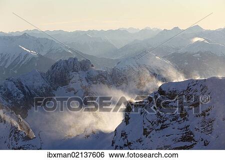 Stock Photograph - "View from Zugspitze Mountain over Gruenstein und Tschirgant Mountains, Wetterstein Mountains, Tyrol, Austria, Europe". Fotosearch