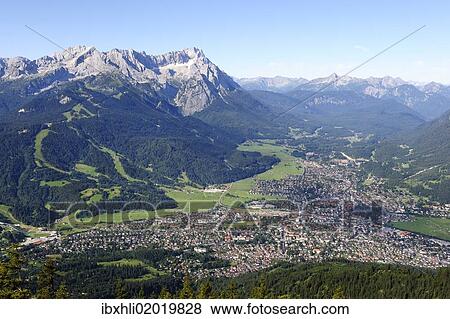 "View of Garmisch-Partenkirchen, Zugspitze mountain, Jubilaeumsgrat ridge and Alpspitze mountain as seen from Wank mountain, Upper Bavaria, Bavaria, Germany, Europe" View Large Photo Image Stock Photo - "View of Garmisch-Partenkirchen, Zugspitze mountain, Jubilaeumsgrat ridge and Alpspitze mountain as seen from Wank mountain, Upper Bavaria, Bavaria, Germany, Europe". Fotosearch