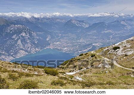 Stock Photography - "View of Lake Garda and Arco, on the way to the top of Monte Altissimo mountain above Nago-Torbole, province of Trentino, Italy, Europe". Fotosearch